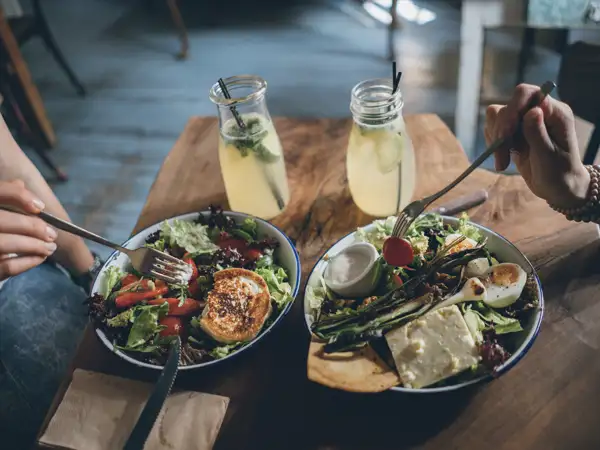 Two people enjoying salads